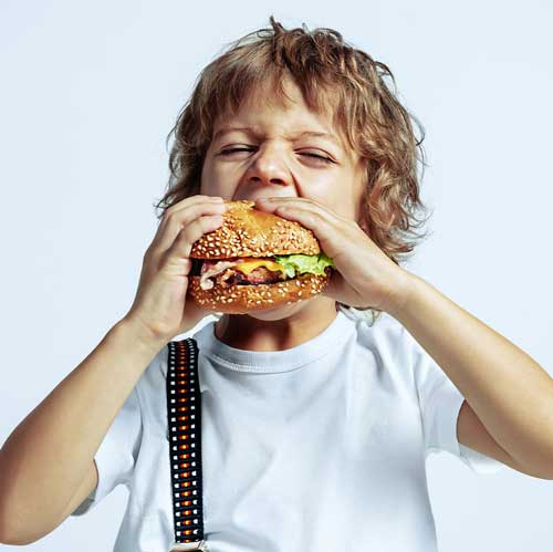 kid-eating-burger-at-Nith-Valley-Butcher-&-Deli